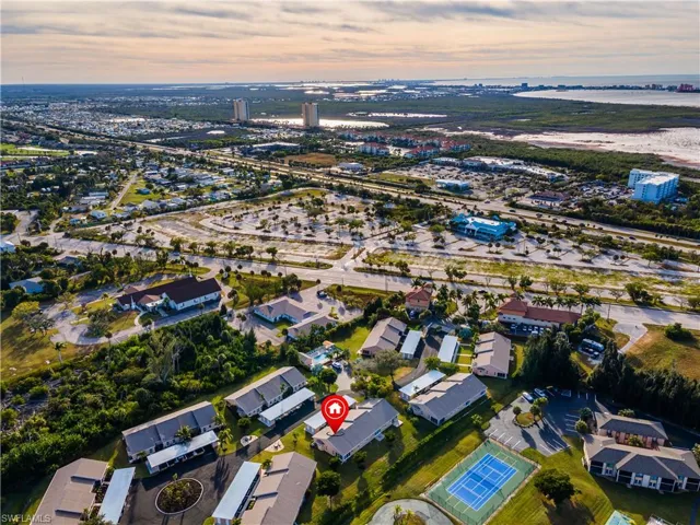 Aerial view of property and surrounding area featuring a large body of water and future site of Calusa Grande