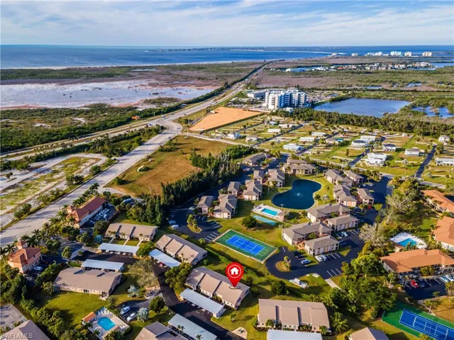 Aerial overview of property's location with a large body of water and nearby suburban area