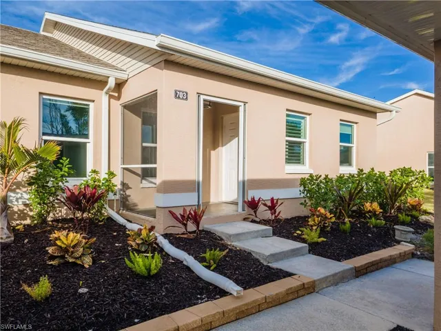 View of exterior entry featuring stucco siding
