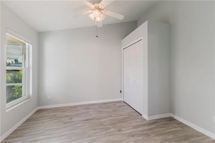 3rd bedroom featuring light wood-style flooring, a closet, and a ceiling fan