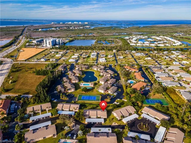 View of property location featuring a large body of water and nearby suburban area