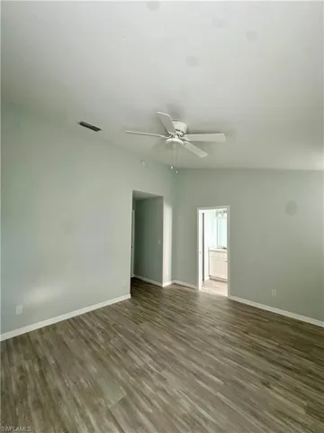 master bedroom with dark wood-style floors and ceiling fan