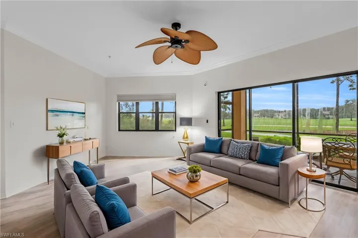 Living room with ceiling fan, light hardwood / wood-style flooring, ornamental molding, and a healthy amount of sunlight