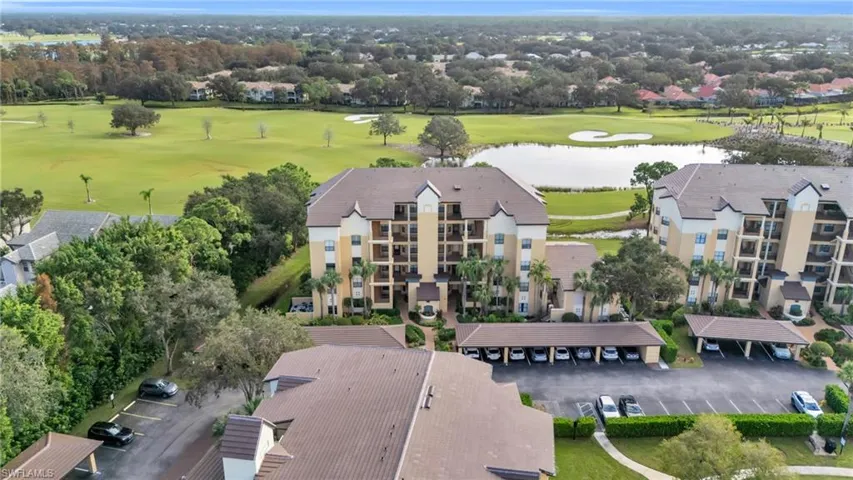Birds eye view of property with a water view