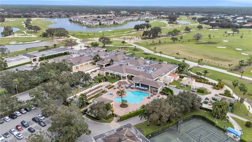 Birds eye view of property with a water view