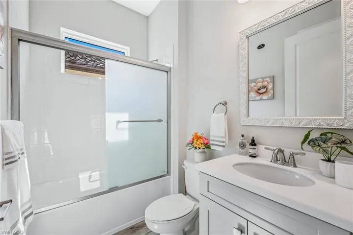 Bathroom with vanity and shower / bath combination with glass door