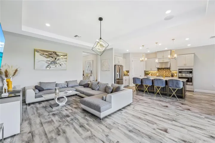 Living room with a chandelier, recessed lighting, and light wood-style floors