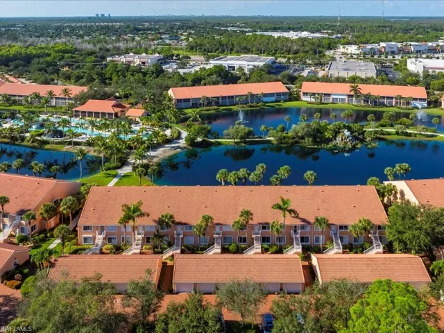 Drone / aerial view of apartment complex and a large body of water