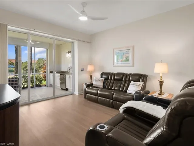 Living area featuring wood finished floors and ceiling fan