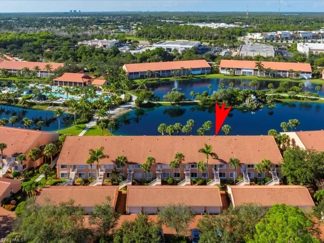 Bird's eye view of apartment complex and a nearby body of water