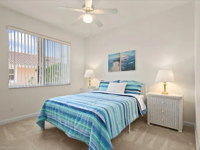 Carpeted bedroom with baseboards and ceiling fan