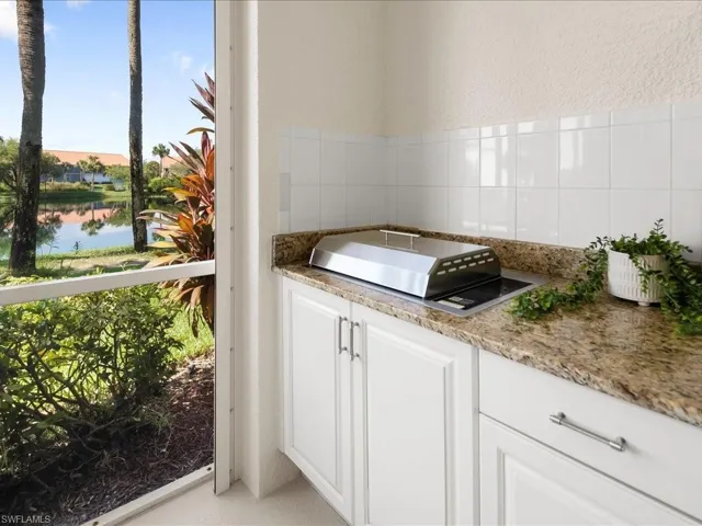 Bathroom featuring a textured wall, a water view, and tile walls
