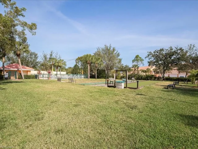 View of property's community with a lawn