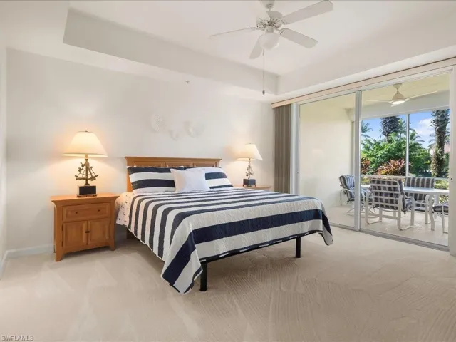 Bedroom featuring access to exterior, carpet flooring, and a ceiling fan