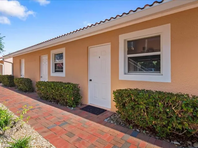Entrance to property featuring a tile roof and stucco siding