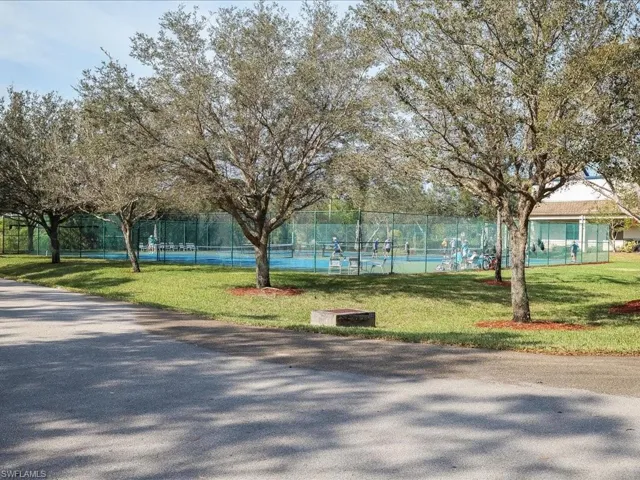 View of community featuring a tennis court