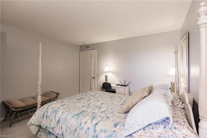Carpeted bedroom featuring a textured ceiling