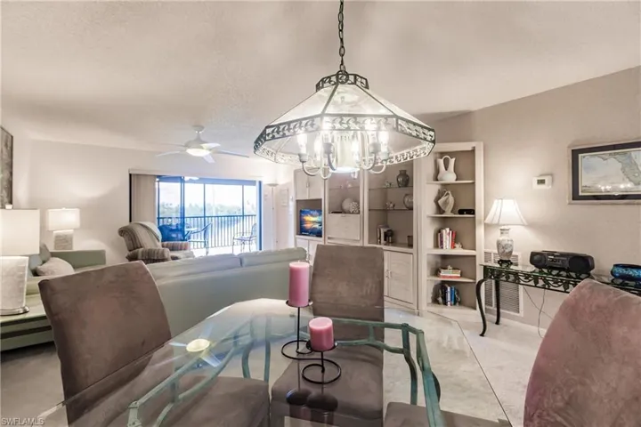 Carpeted dining space featuring ceiling fan and a textured ceiling