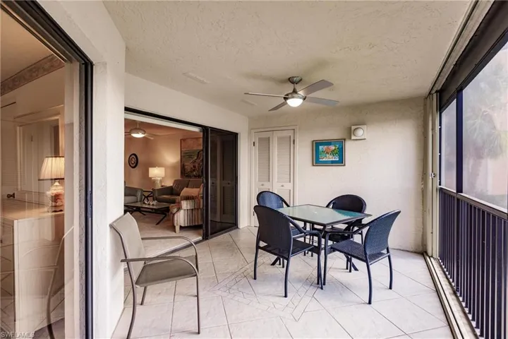 Sunroom / solarium with a ceiling fan, outdoor dining area, and baseboard heating