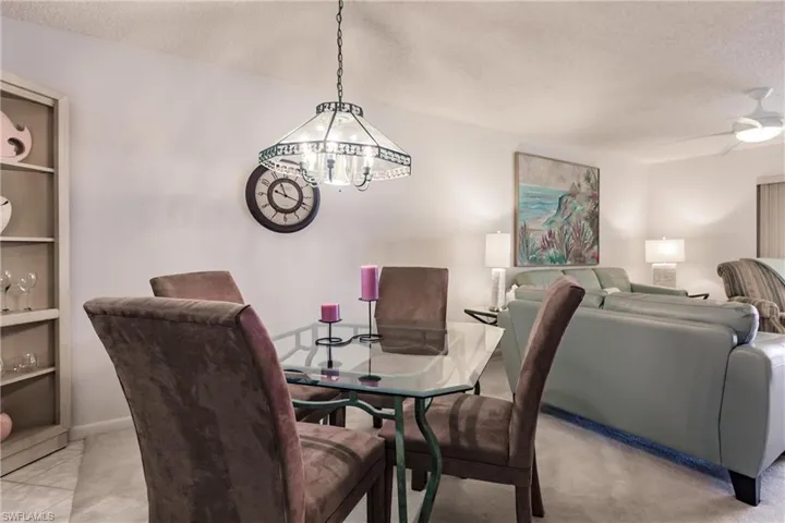 Dining room with a textured ceiling and a ceiling fan