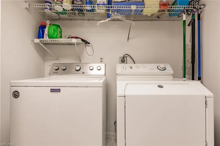 Laundry room with washer and clothes dryer