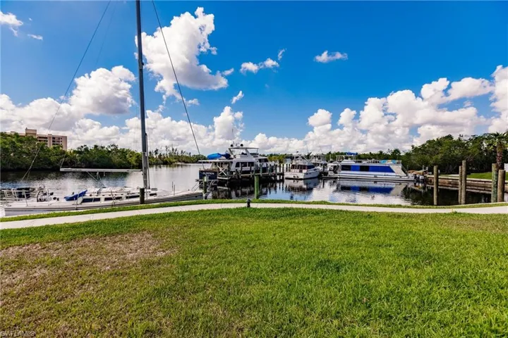 Dock with a water view and a yard