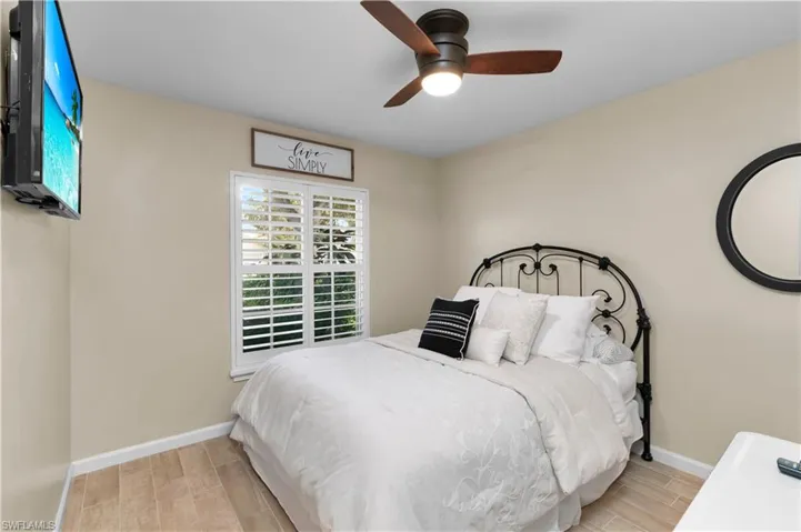 Bedroom featuring wood finish floors and ceiling fan