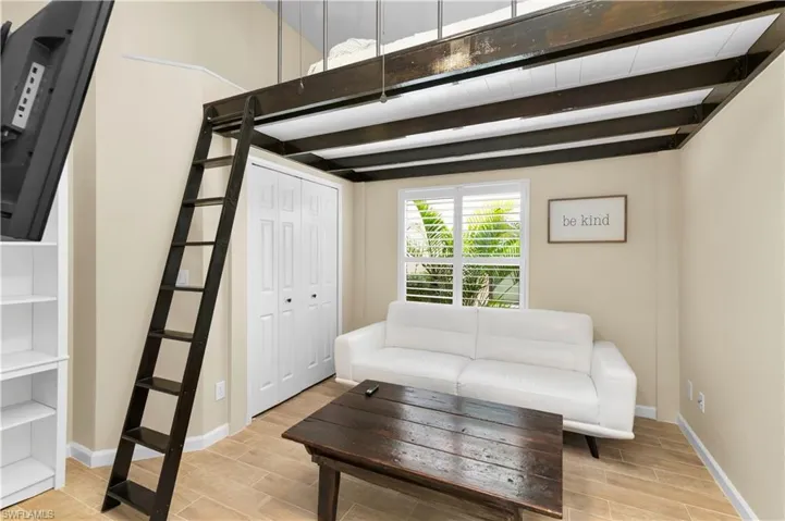 Living room with beamed ceiling and wood tiled floors