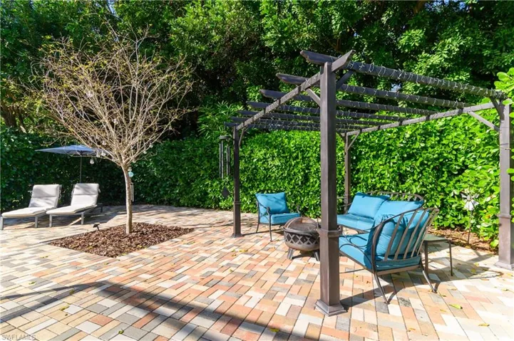 View of patio featuring a pergola and an outdoor living space with a fire pit