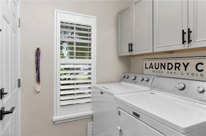 Laundry room with cabinet space and independent washer and dryer