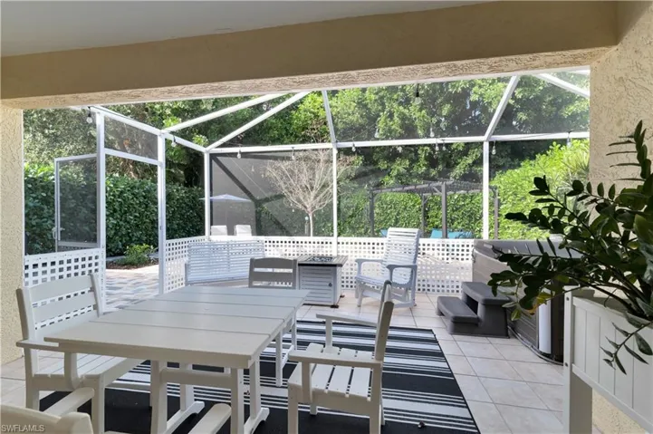 View of patio / terrace featuring a sunroom, a lanai, and outdoor dining space