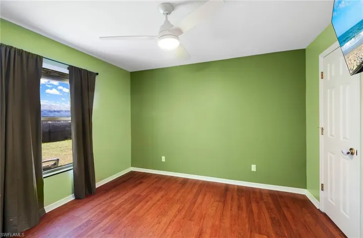 Spare room featuring hardwood / wood-style floors and ceiling fan