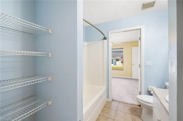 Bathroom featuring tile patterned flooring and vanity