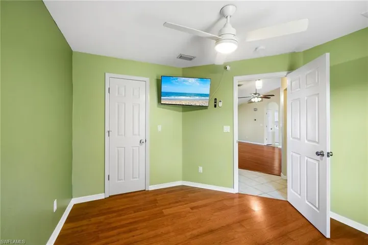 Unfurnished bedroom featuring light wood-type flooring, a closet, and ceiling fan