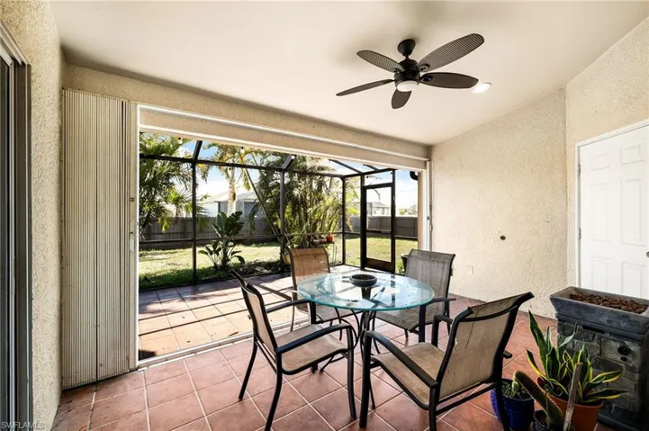 Sunroom with ceiling fan and lofted ceiling