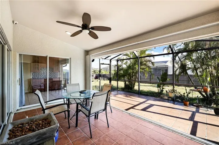 Sunroom with ceiling fan and vaulted ceiling