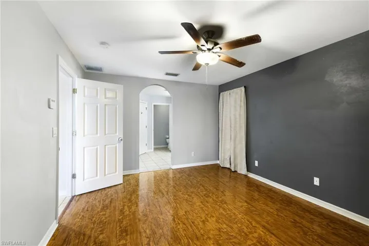 Unfurnished room with light wood-type flooring and ceiling fan