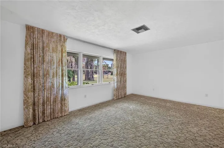 Actual Primary Bedroom featuring a Large Window that looks out onto the Beautiful Property