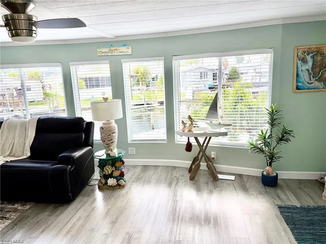 Living area with light wood finished floors and baseboards