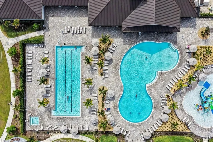 Extensive amenity center featuring three distinct swimming pools, including a lap pool, a freeform pool, and a splash pad and a spa