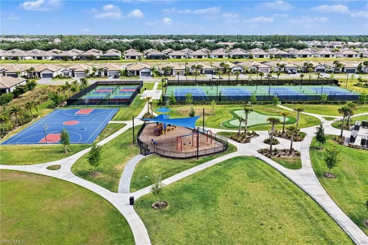 Community recreation area featuring a basketball court, tennis courts, pickleball courts, and a playground with shade structures