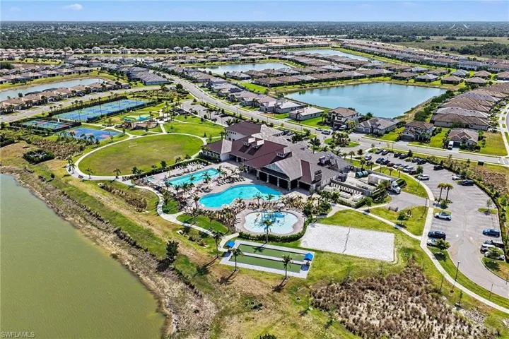 Expansive community amenities including multiple swimming pools, a clubhouse, tennis courts, bocce ball courts, and a sand volleyball court
