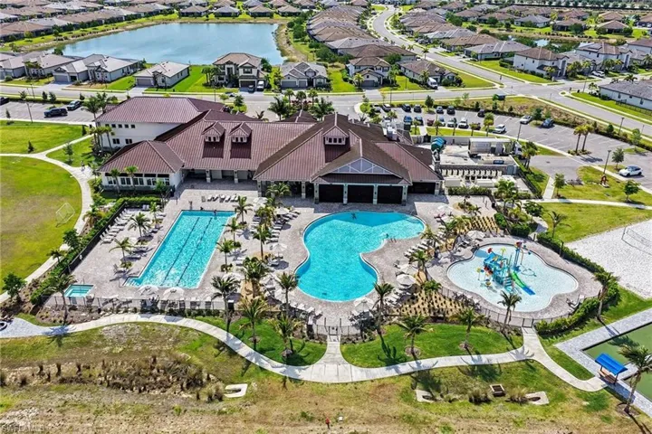 Community amenity center featuring a resort-style swimming pool, lap pool, and a children's splash pad
