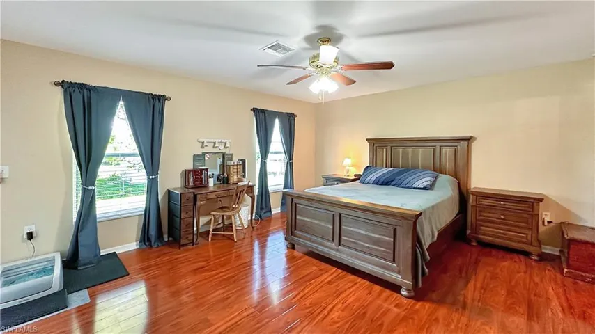Bedroom with ceiling fan and wood-type flooring