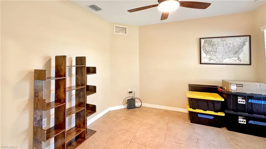 Office area with light tile patterned flooring and ceiling fan