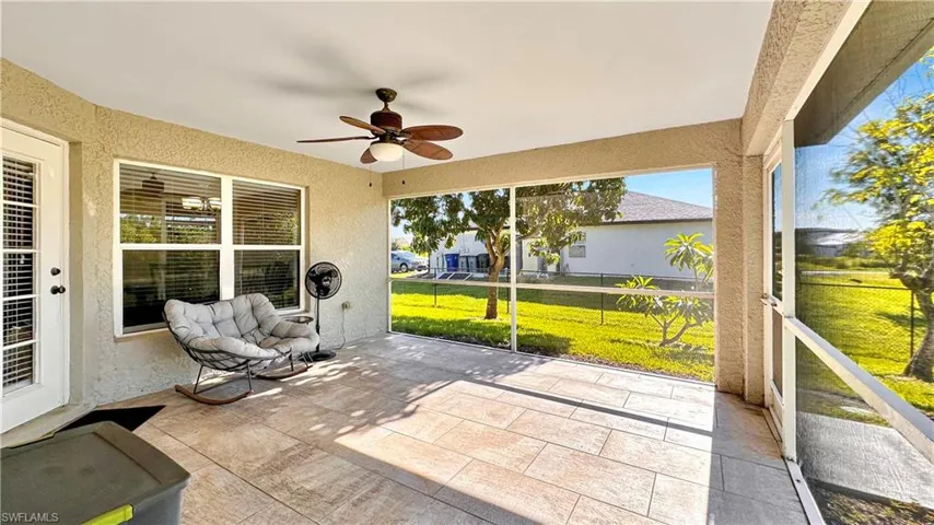 Unfurnished sunroom with ceiling fan