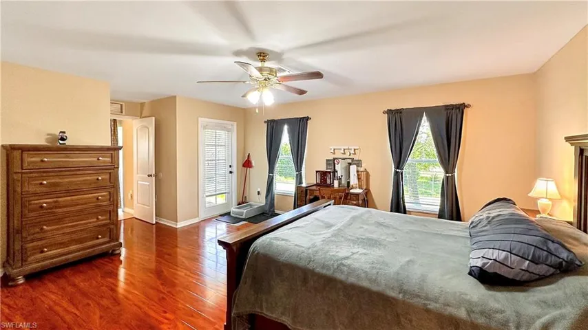 Bedroom featuring ceiling fan and dark hardwood / wood-style flooring