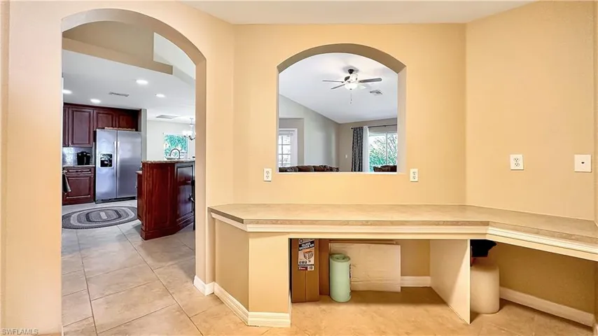 Corridor with sink and light tile patterned floors