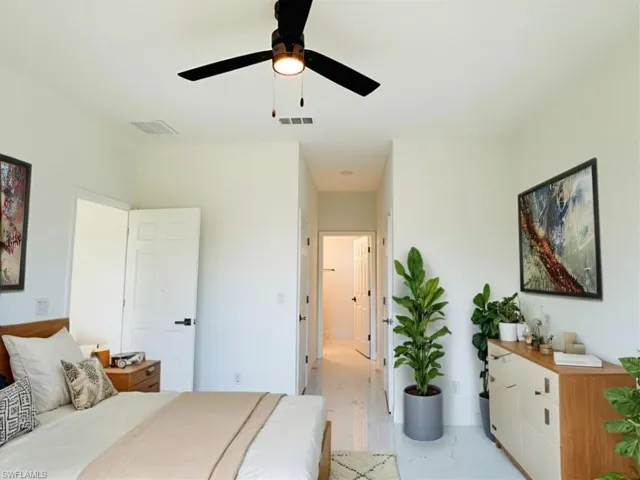 Virtually staged primary bedroom with a ceiling fan