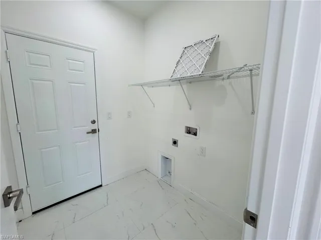Laundry room with light marble finish flooring, electric dryer hookup, and hookup for a washing machine